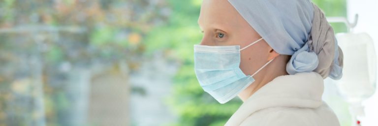 Panorama of weak woman with a mask on her face during treatment