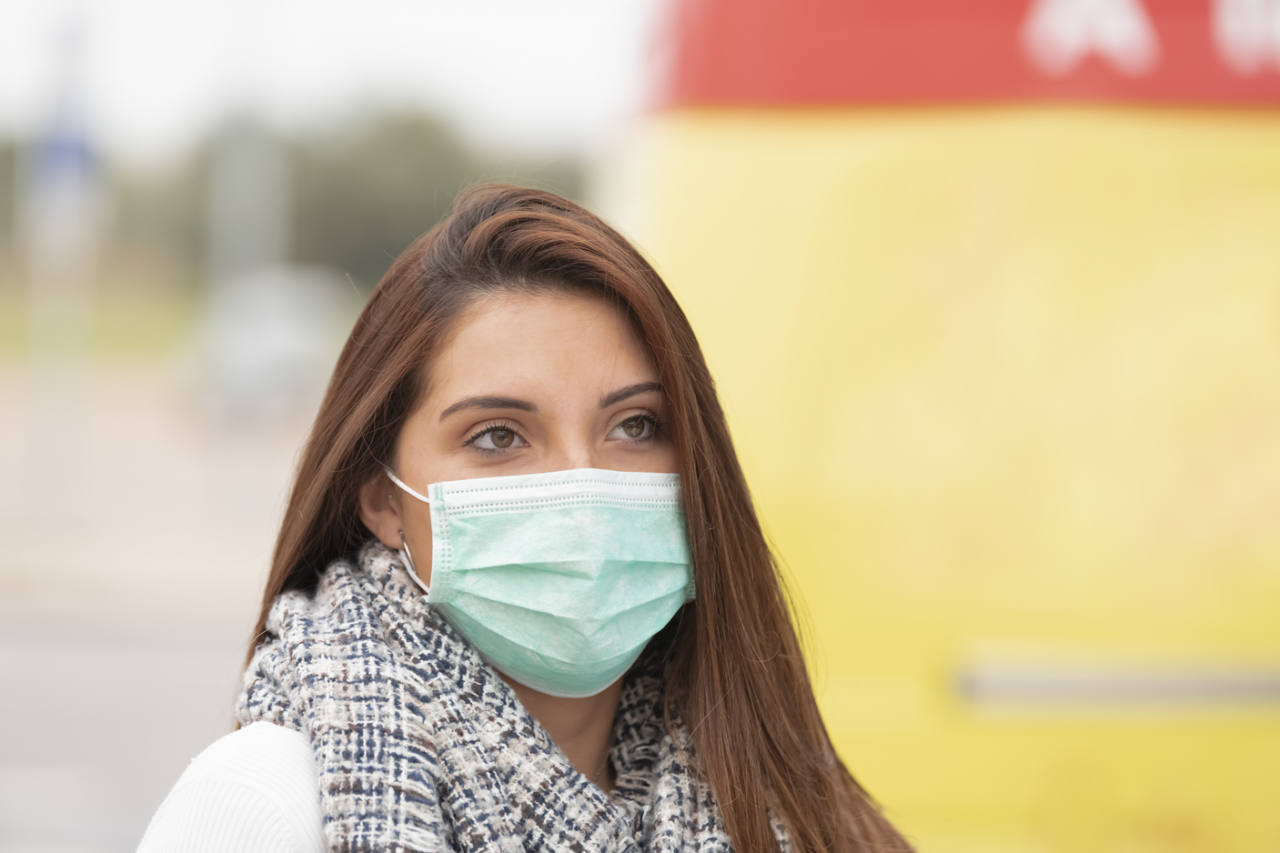 Closeup of a sad looking woman wearing a mask