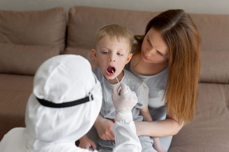 Doctor takes a cotton bud from child mouth to analyze the saliva, mucous membrane for DNA tests, COVID-19, to determine or presence of virus, SARS-CoV-2 epidemic, coronavirus concept