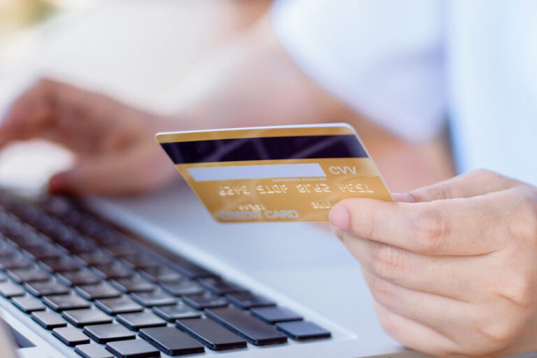 Online Payment . Woman hands holding credit card and using lapto