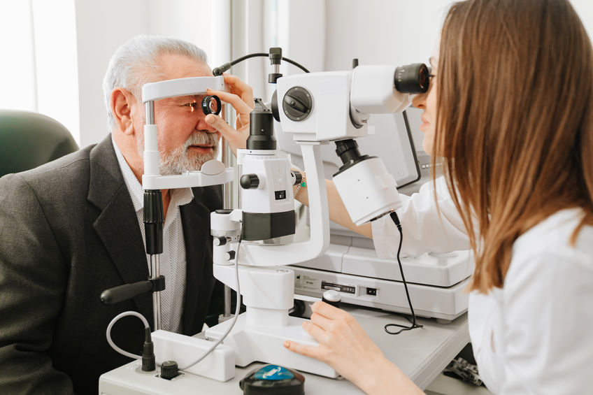 ophthalmologist examination of elderly man with slit lamp. medical equipment