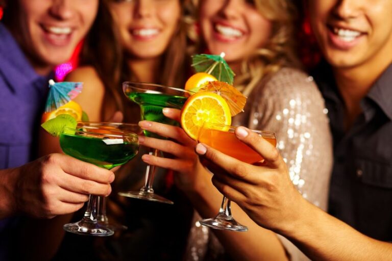 10627463 - close-up of several cocktails in young people hands