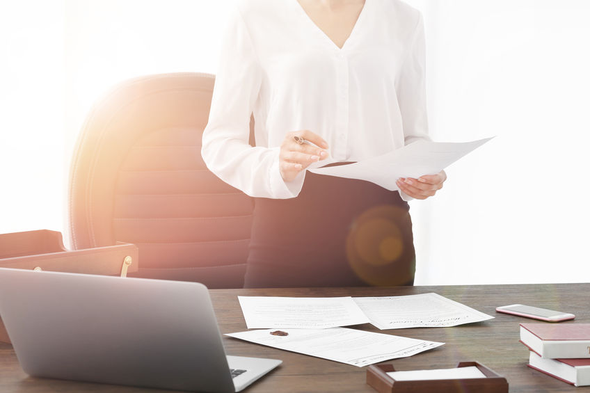 Successful businesswoman working with documents in office