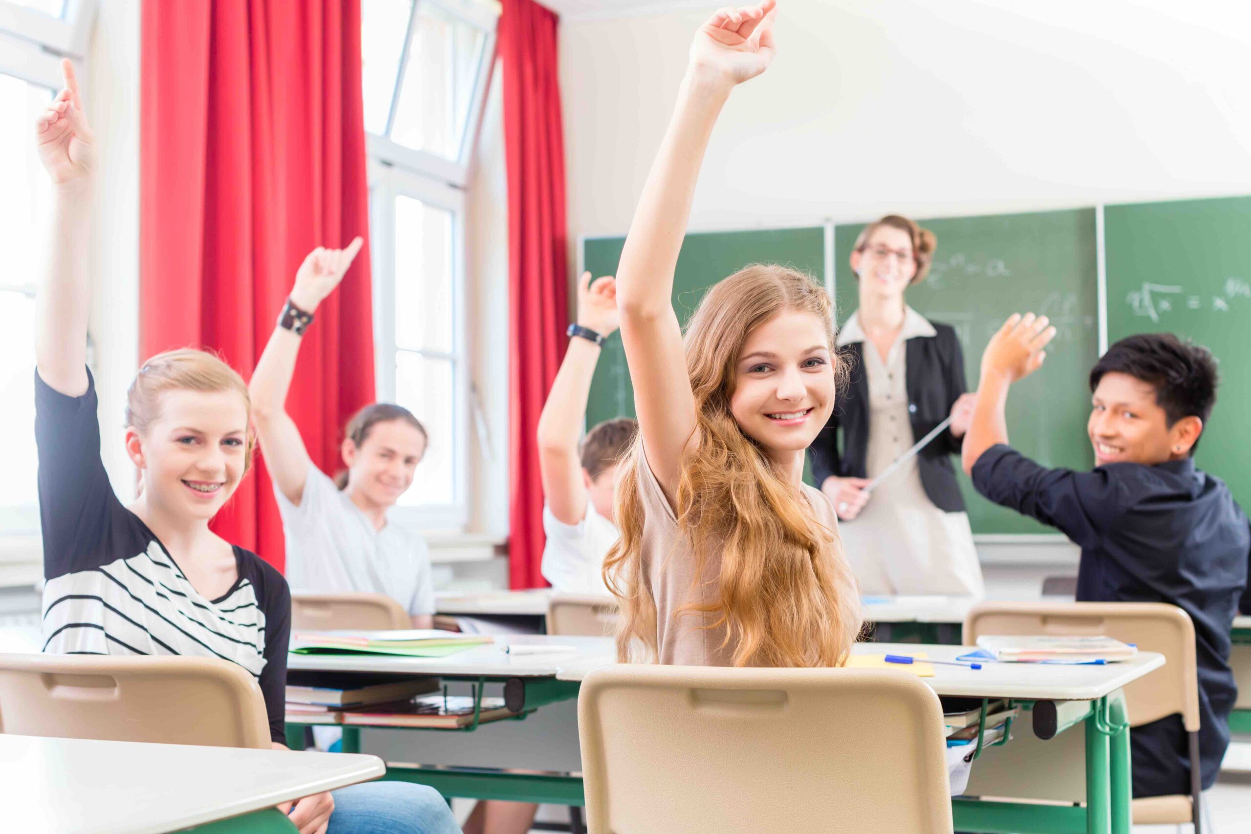 Teacher teaching a class of  pupils in school