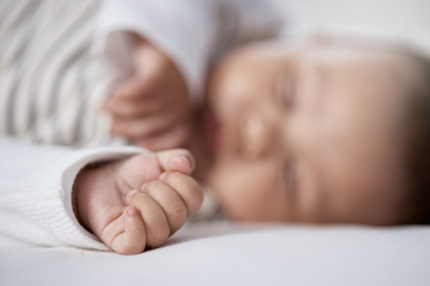 Babies need lots of sleep to grow. Closeup shot of a babys hand while asleep at home.
