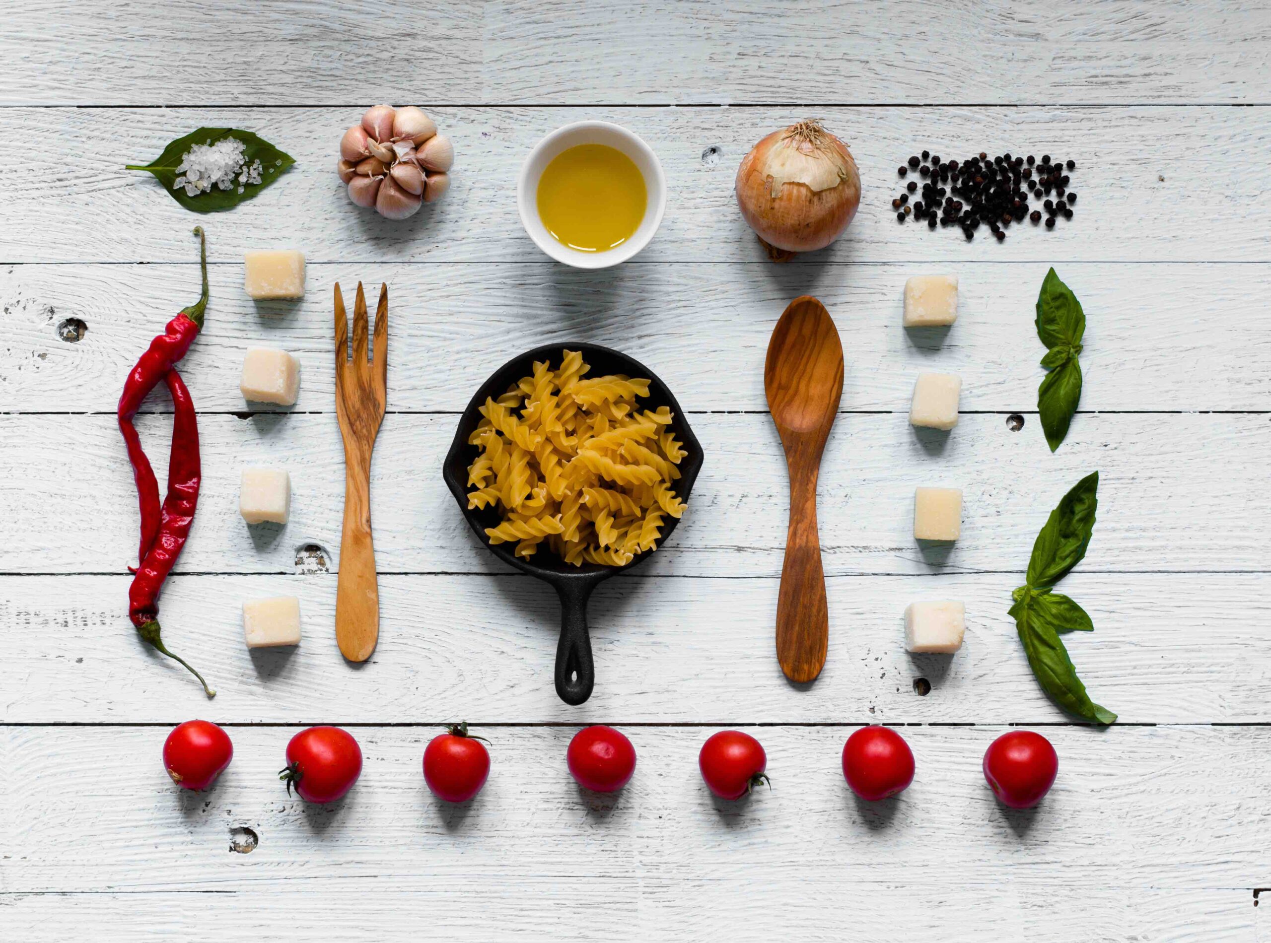 Top view of all the necessary food component to make a classic italian pasta