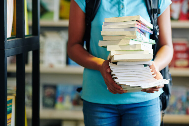 Unrecognizable Schoolgirl With Books