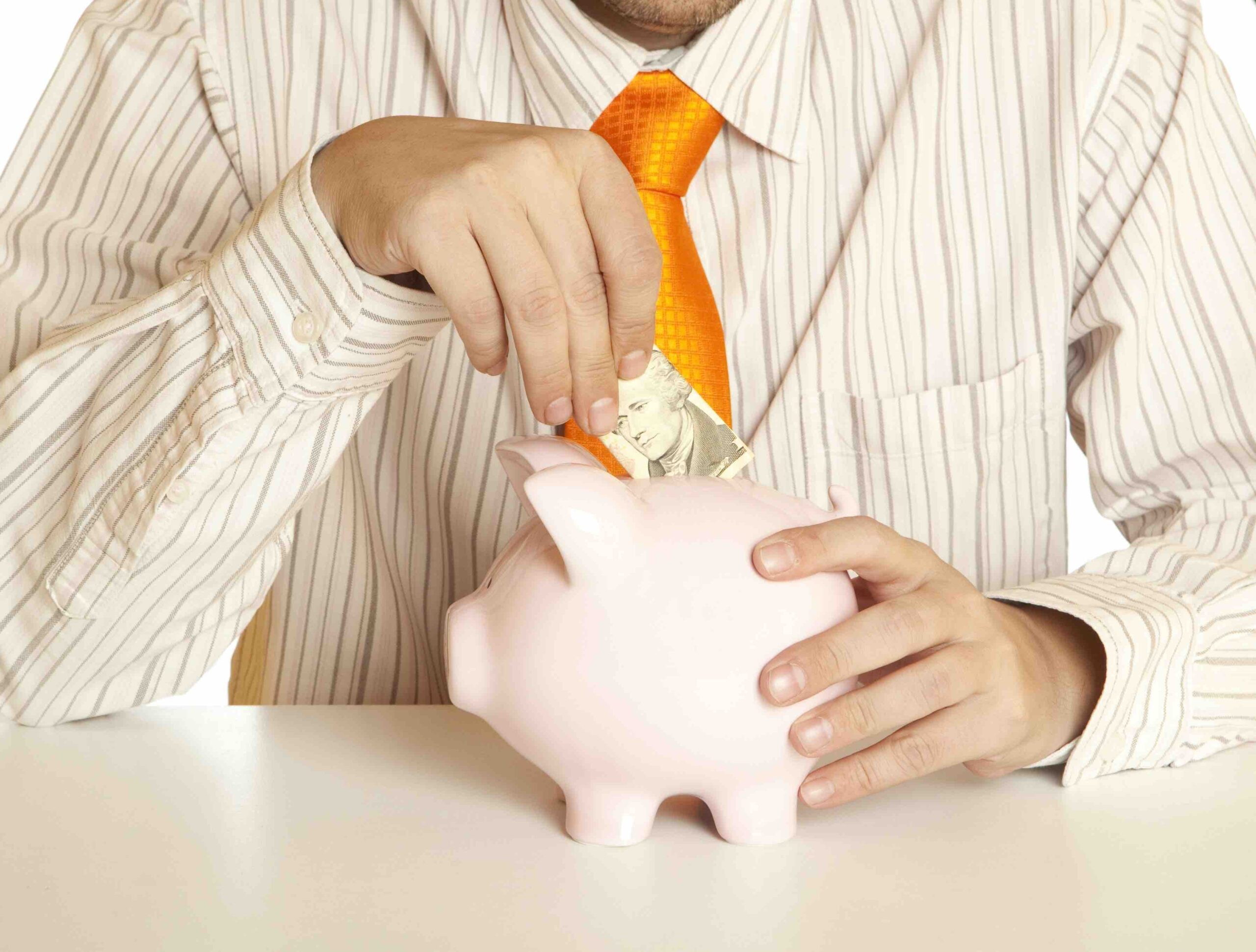 15422266 - male hand putting coins into a piggy bank