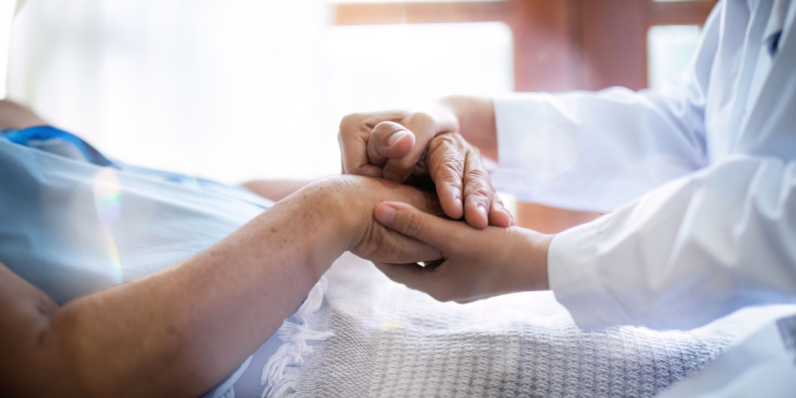 Empathy, trust and nurse caregiver holding hands with patient. consulting support and healthcare advice. Kindness, counseling and medical therapy in nursing home for hope, consultation and psychology