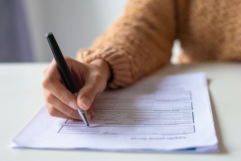 Close-up of lady filling application form