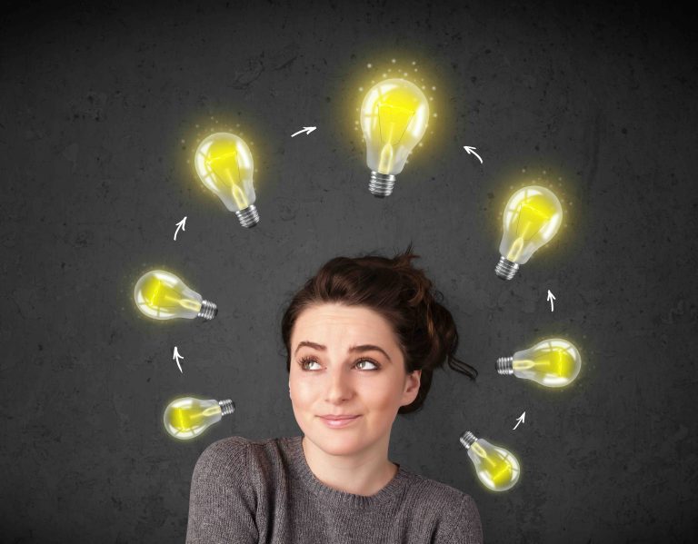 Young woman thinking with lightbulb circulation around her head