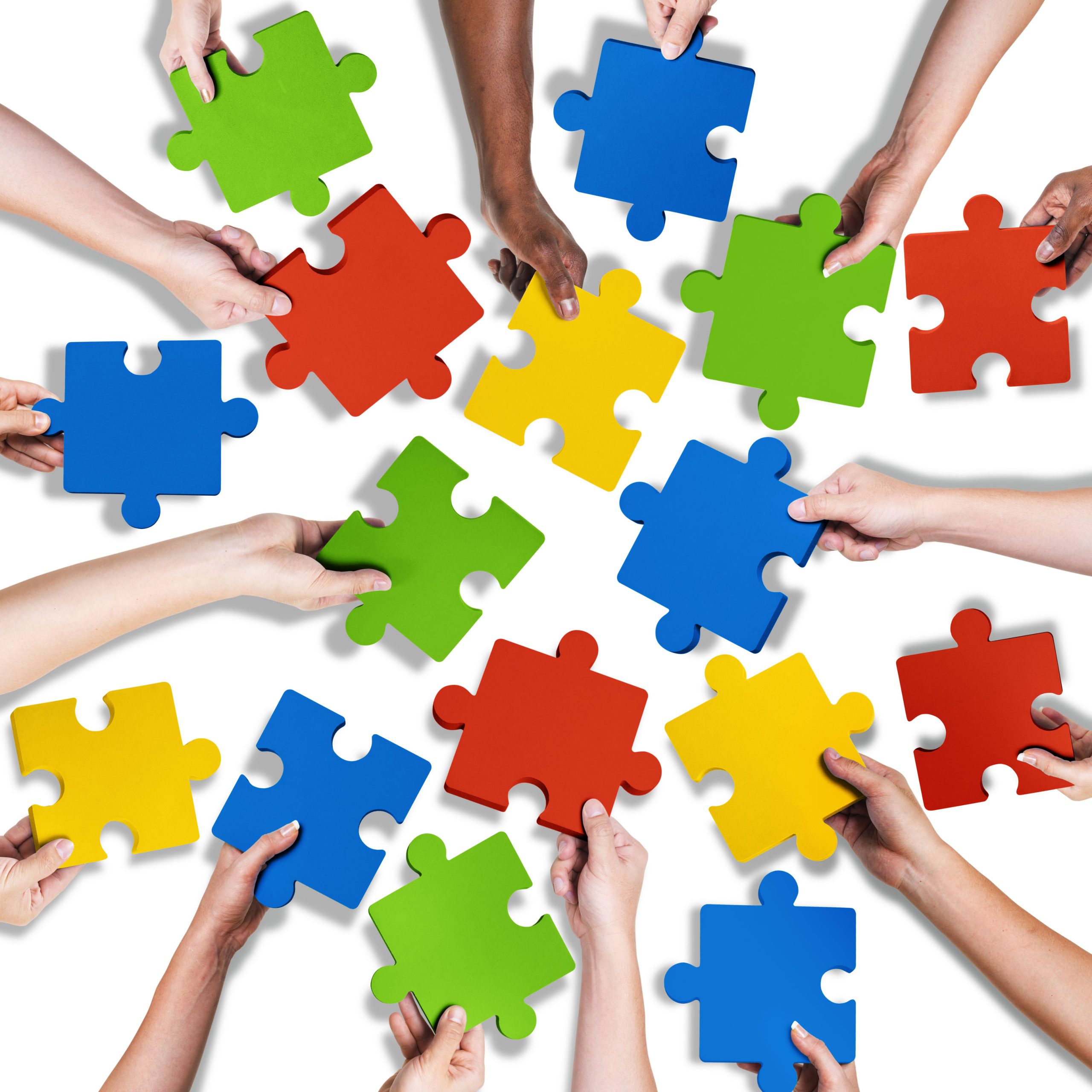 34574778 - group of diverse hands holding jigsaw puzzle