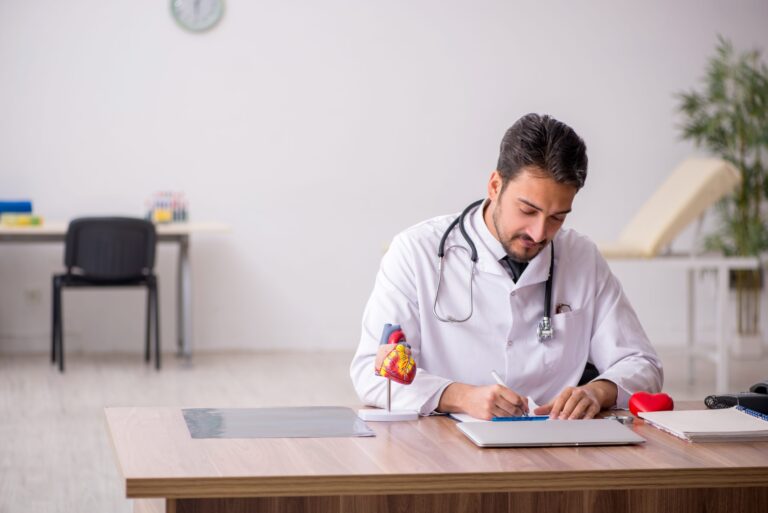 Young male doctor cardiologist working in the clinic