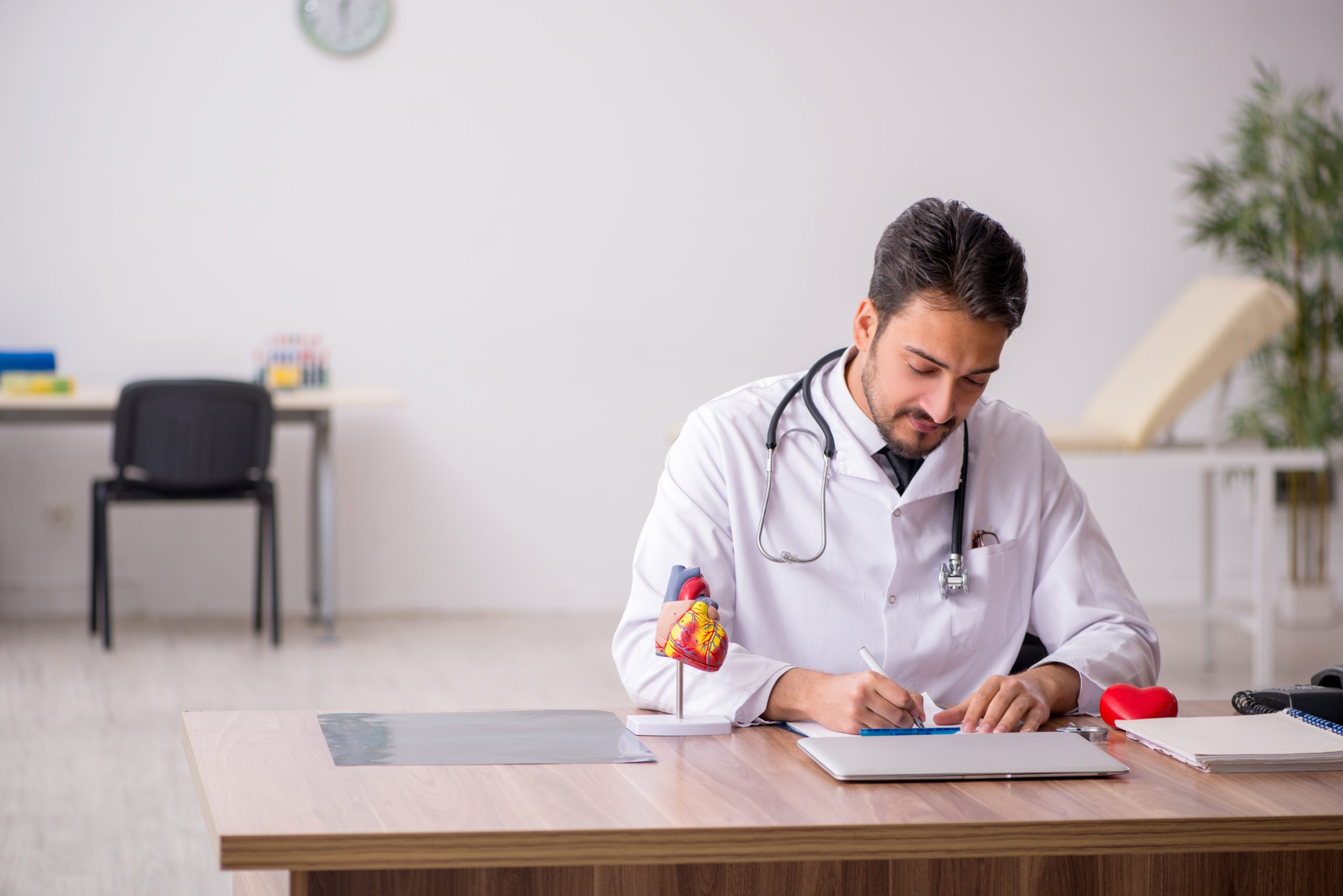 Young male doctor cardiologist working in the clinic